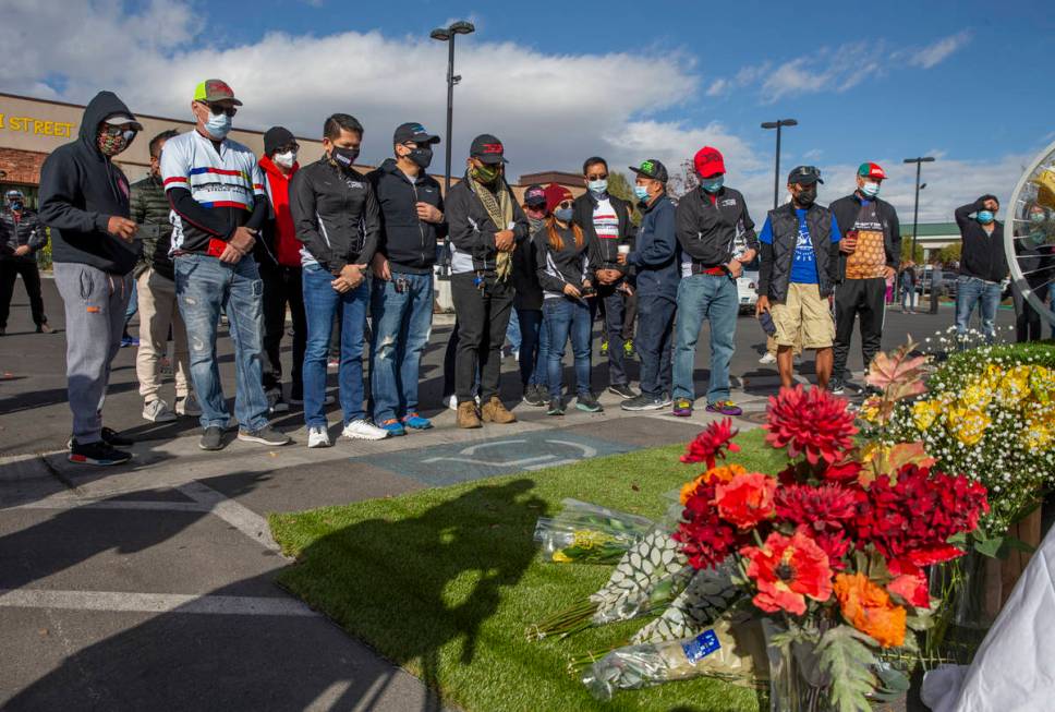 Members of the 702Shifters gather before a growing memorial during a vigil honoring the lives o ...
