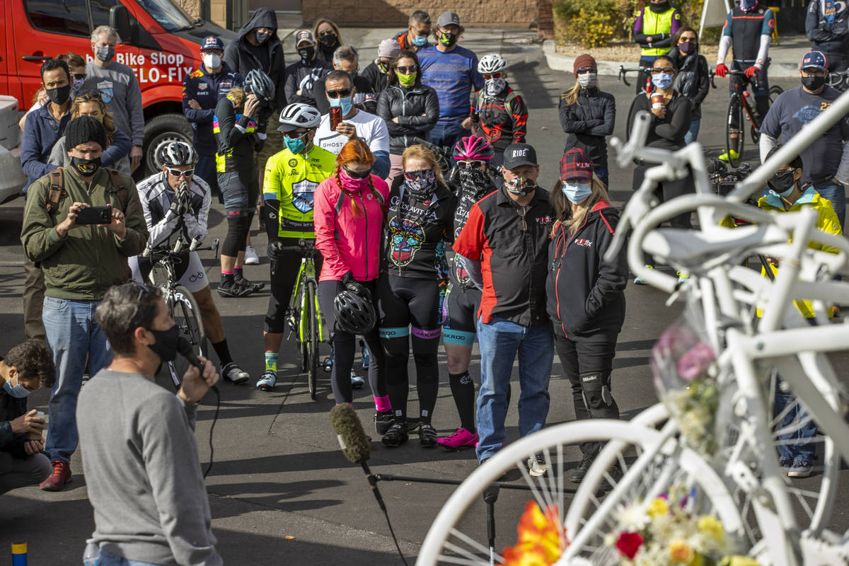 Attendees listen to inspirational words spoken by Pat Treichel with Ghost Bikes during a vigil ...