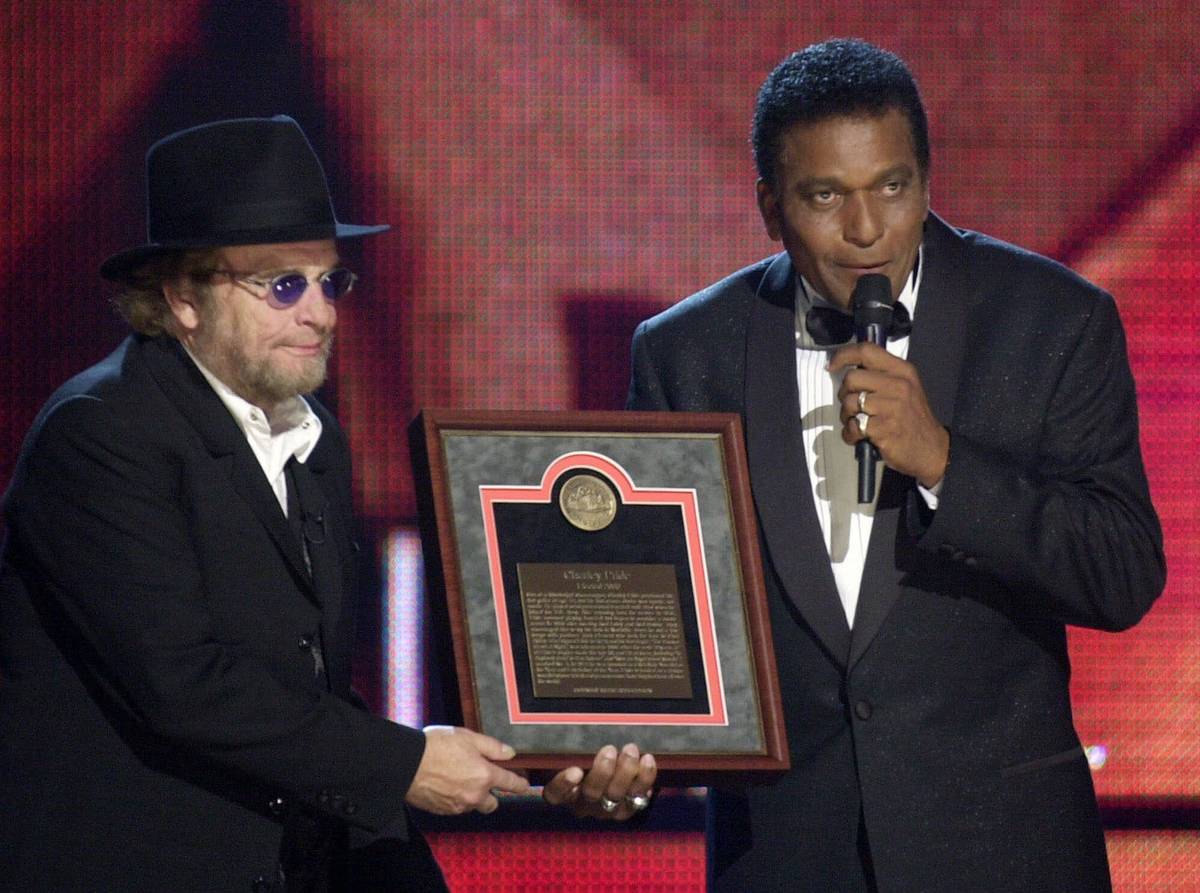 FILE - In this Oct. 4, 2000, file photo, Charlie Pride, right, receives his Country Music Hall ...