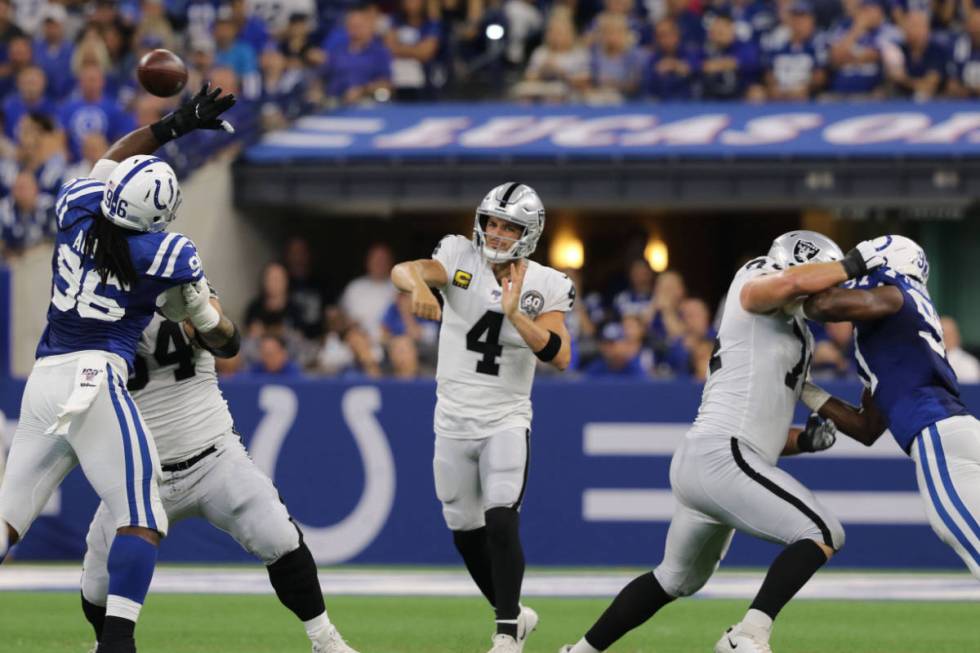 Raiders quarterback Derek Carr (4) throws the football over Indianapolis Colts defensive end Ty ...