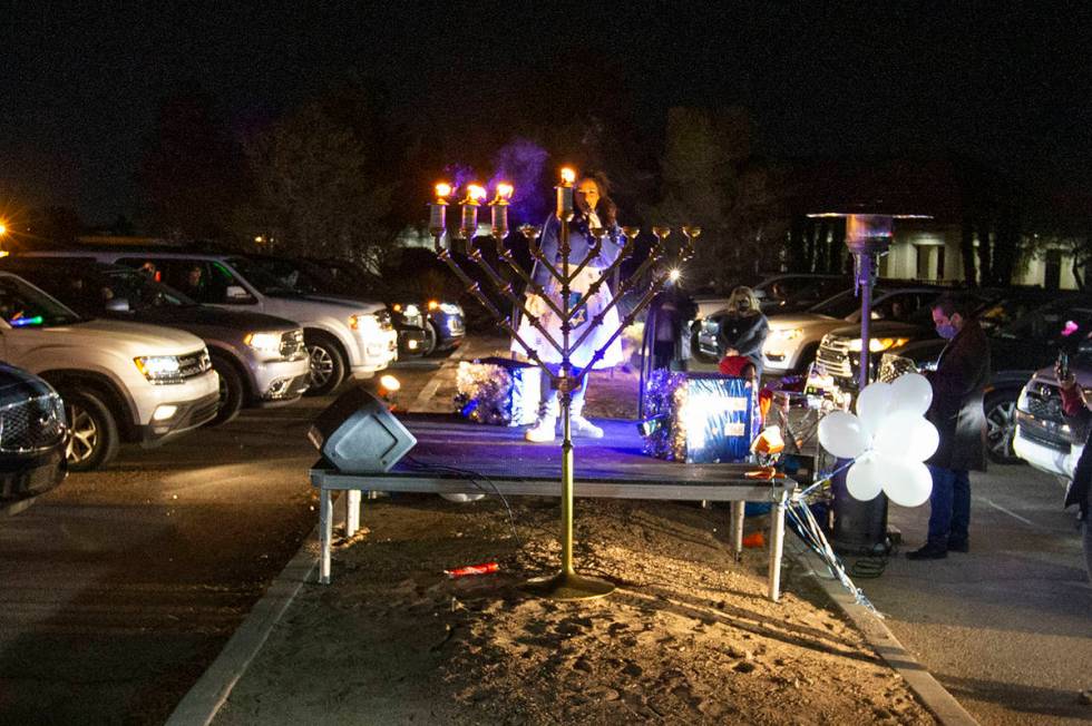 Singer Rinat Hahmigery performs after the menorah was lighted Saturday night at a drive-in Hanu ...
