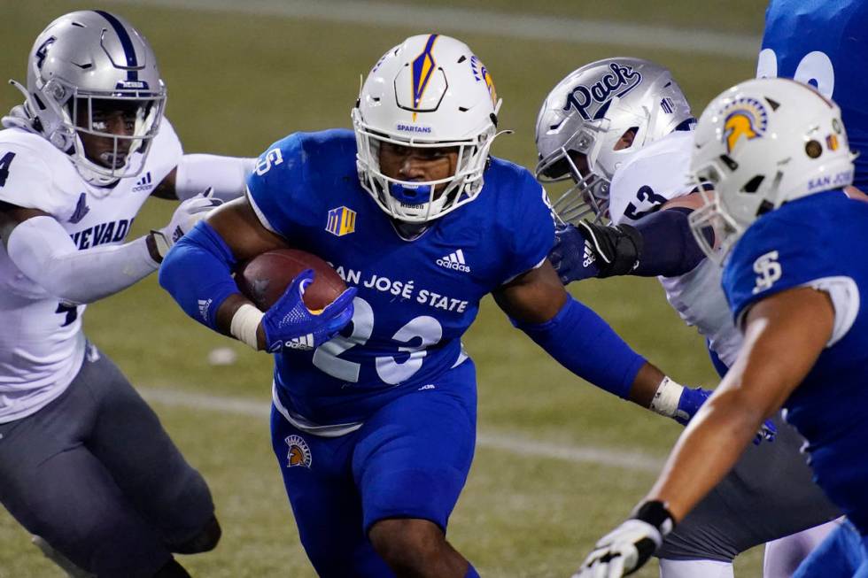 San Jose State running back Tyler Nevens (23) runs past UNR defensive back EJ Muhammad (4) for ...