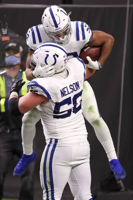 Indianapolis Colts running back Jonathan Taylor (28) celebrates a touchdown with Indianapolis C ...