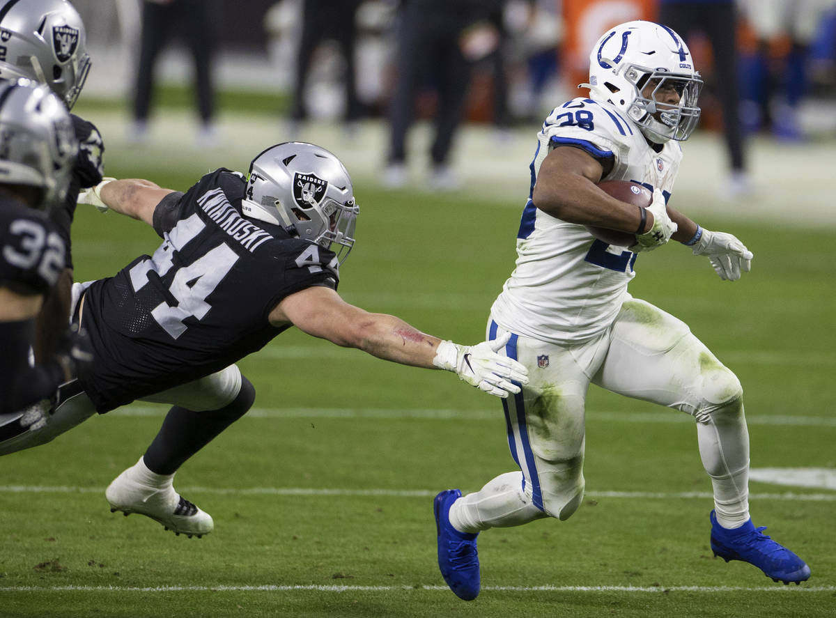 Indianapolis Colts running back Jonathan Taylor (28) bursts up field past Raiders inside lineba ...