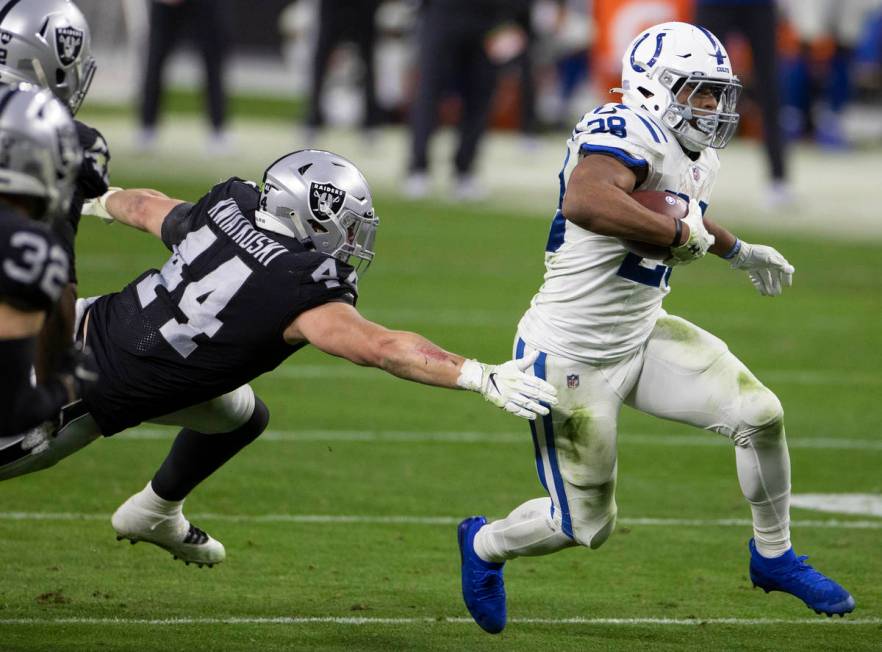 Indianapolis Colts running back Jonathan Taylor (28) bursts up field past Raiders inside lineba ...