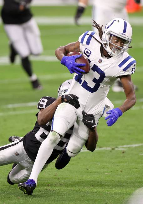 Indianapolis Colts wide receiver T.Y. Hilton (13) is tackled by Raiders free safety Lamarcus Jo ...