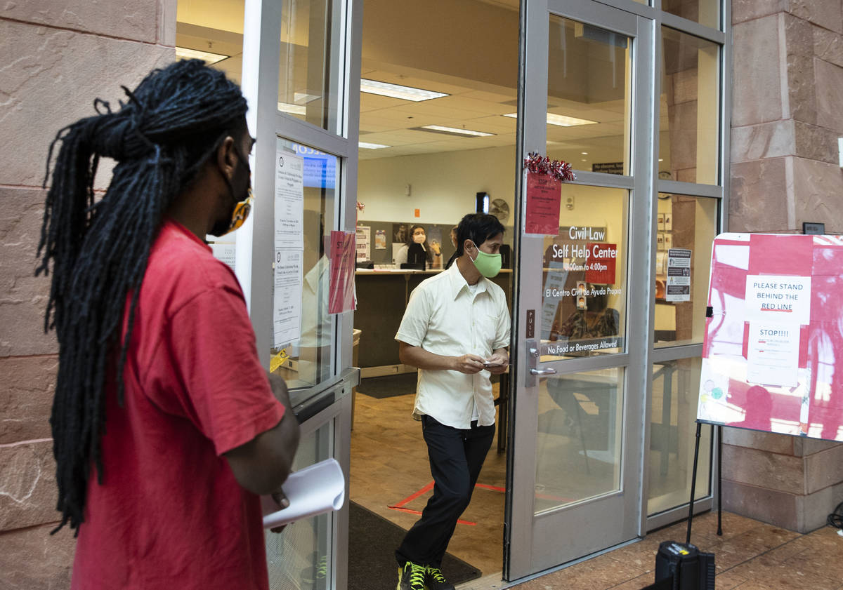 Kenyaday Fitzgerald stand in line outside of the Civil Law Self-Help Center, operated by Legal ...