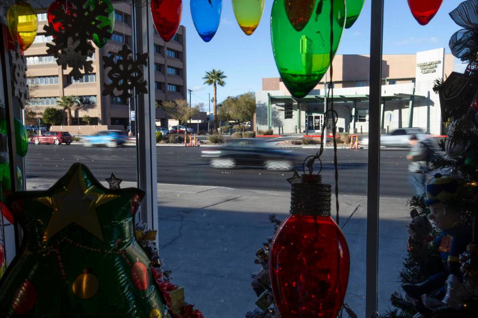 Cars drive down Charleston Boulevard past DiBella Flowers & Gifts on Monday, Dec. 14, 2020, ...