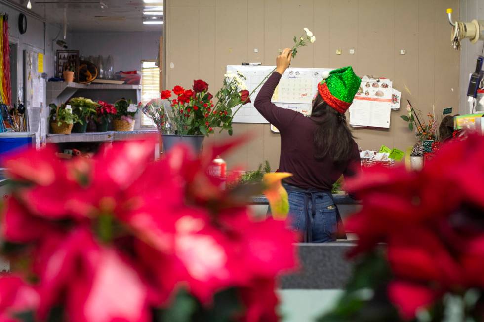 Kayla Sidecko designs a flower arrangement at DiBella Flowers & Gifts on Monday, Dec. 14, 2 ...