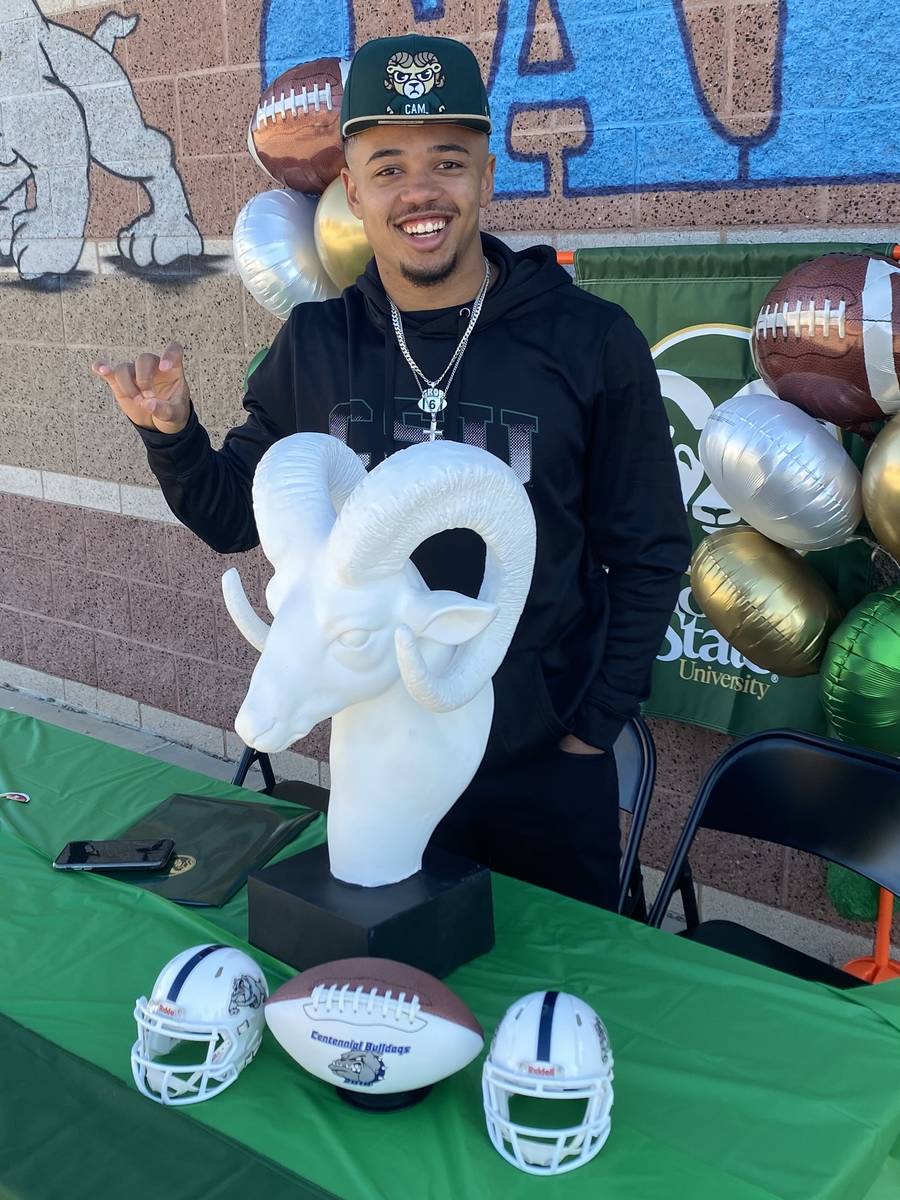 Centennial wide receiver Gerick Robinson poses with a ram statue he received from his youth coa ...