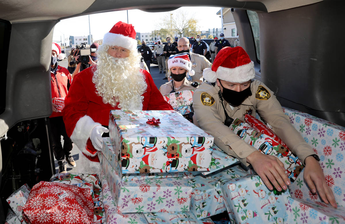 Las Vegas police officers, including Mike Sian, right, A. Karas and Santa prepare for their San ...