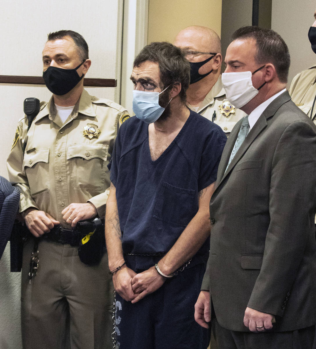 Christopher McDonnell, center, one of three people charged in a shooting spree in Henderson and ...