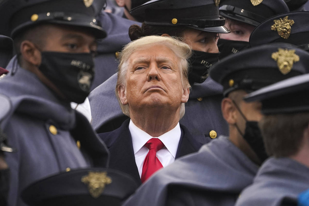 Surrounded by Army cadets, President Donald Trump watches the first half of the 121st Army-Navy ...