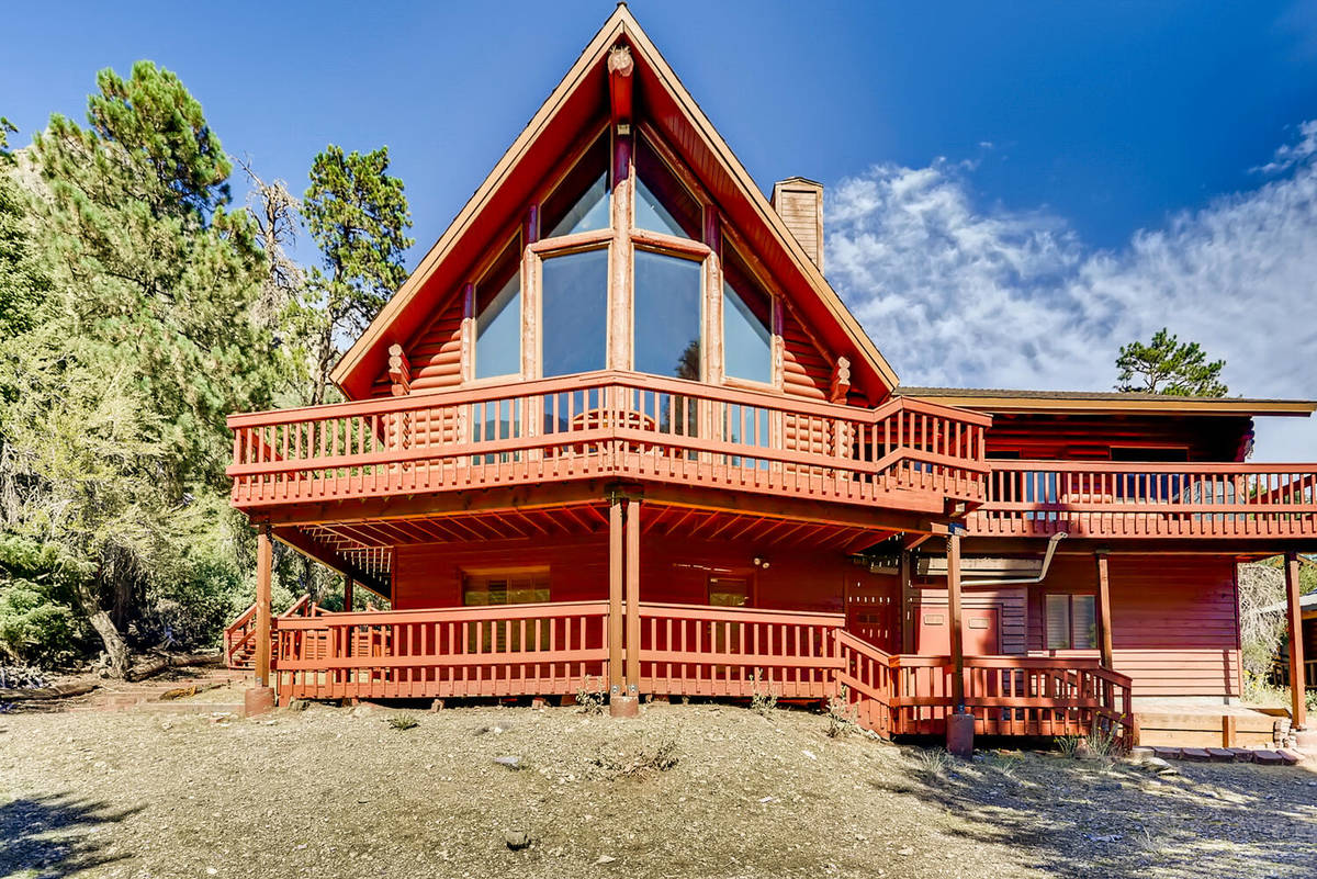 Mt. Charleston Realty The 3,728-square-foot cabin has the forested backdrop of the Toiyabe Nat ...