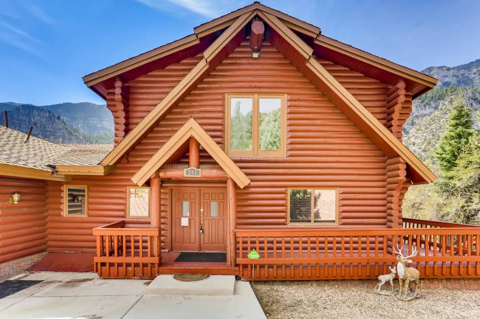 This 3,728-square-foot, custom log cabin on Mount Charleston at 261 Kris Kringle Road has been ...