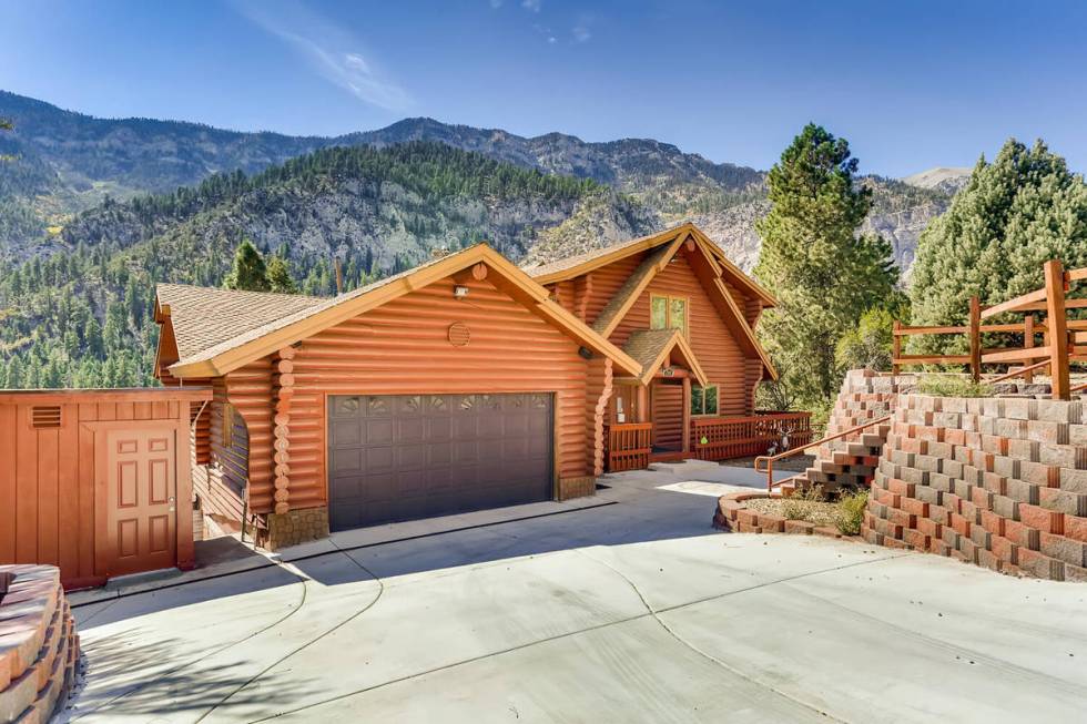 This 3,728-square-foot, custom log cabin on Mount Charleston at 261 Kris Kringle Road has been ...