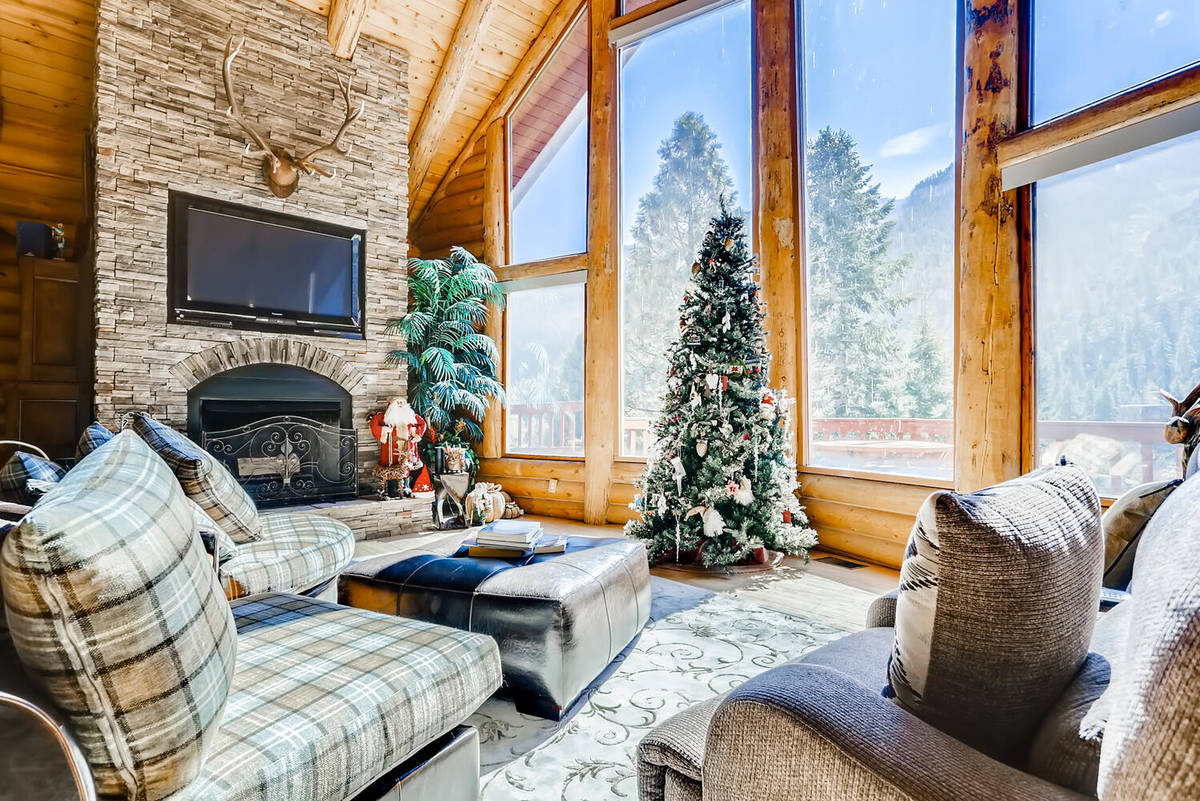 The home's living area has floor-to-ceiling windows that provide views of the Toiyabe National ...