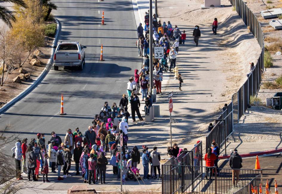 People line up to walk in as the Las Vegas Rescue Mission holds its toy drive on a first-come, ...