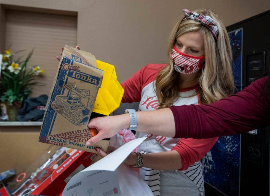 Lacie Jackson, 34, of Las Vegas, packs toys for Christmas donations to be given to families, at ...