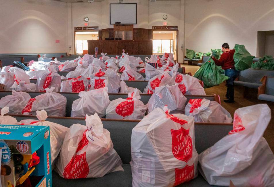 Individual Christmas gifts are organized for each household are seen waiting to be picked up at ...