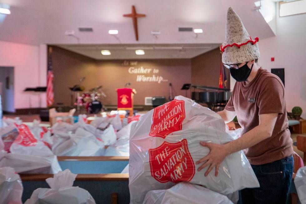 Administrative assistant of family service department Lucas Gordon organizes Christmas toys to ...