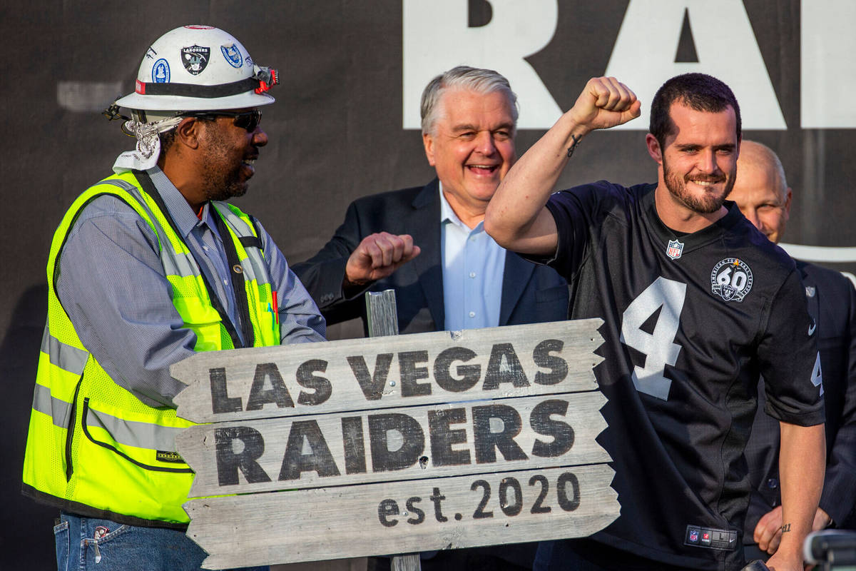 Las Vegas Raiders quarterback Derek Carr (4, center) pump a fist to the crowd after hammering a ...