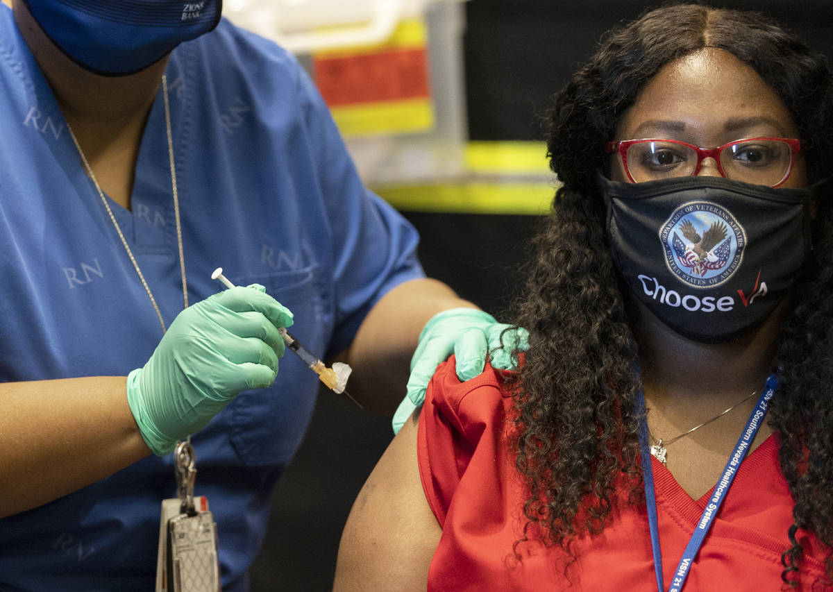 Tymeeka Davis, right, is given the COVID-19 vaccine at the North Las Vegas VA Medical Center on ...