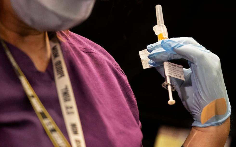 A syringe containing the COVID-19 vaccine at the North Las Vegas VA Medical Center on Wednesday ...