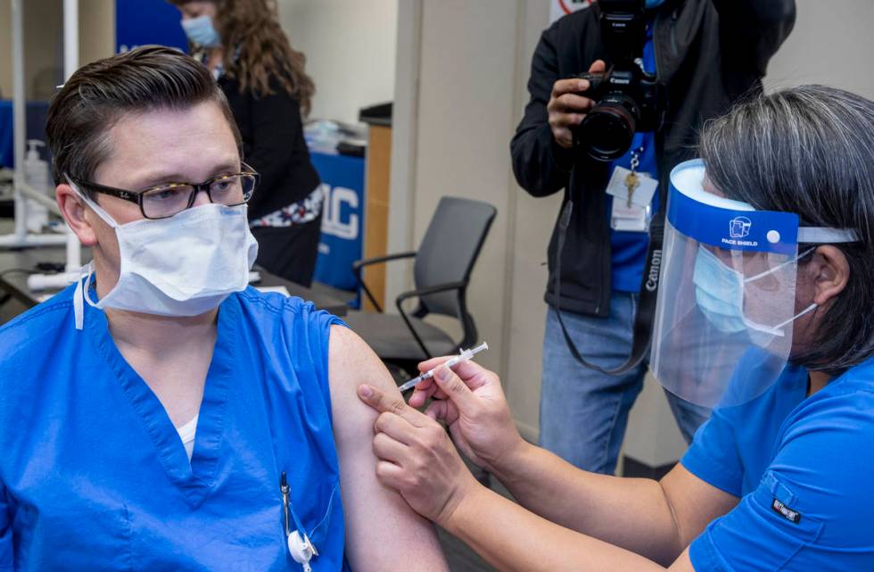 University Medical Center resident physician Tyler Kent, left, is injected by UMCÕs Noel M ...