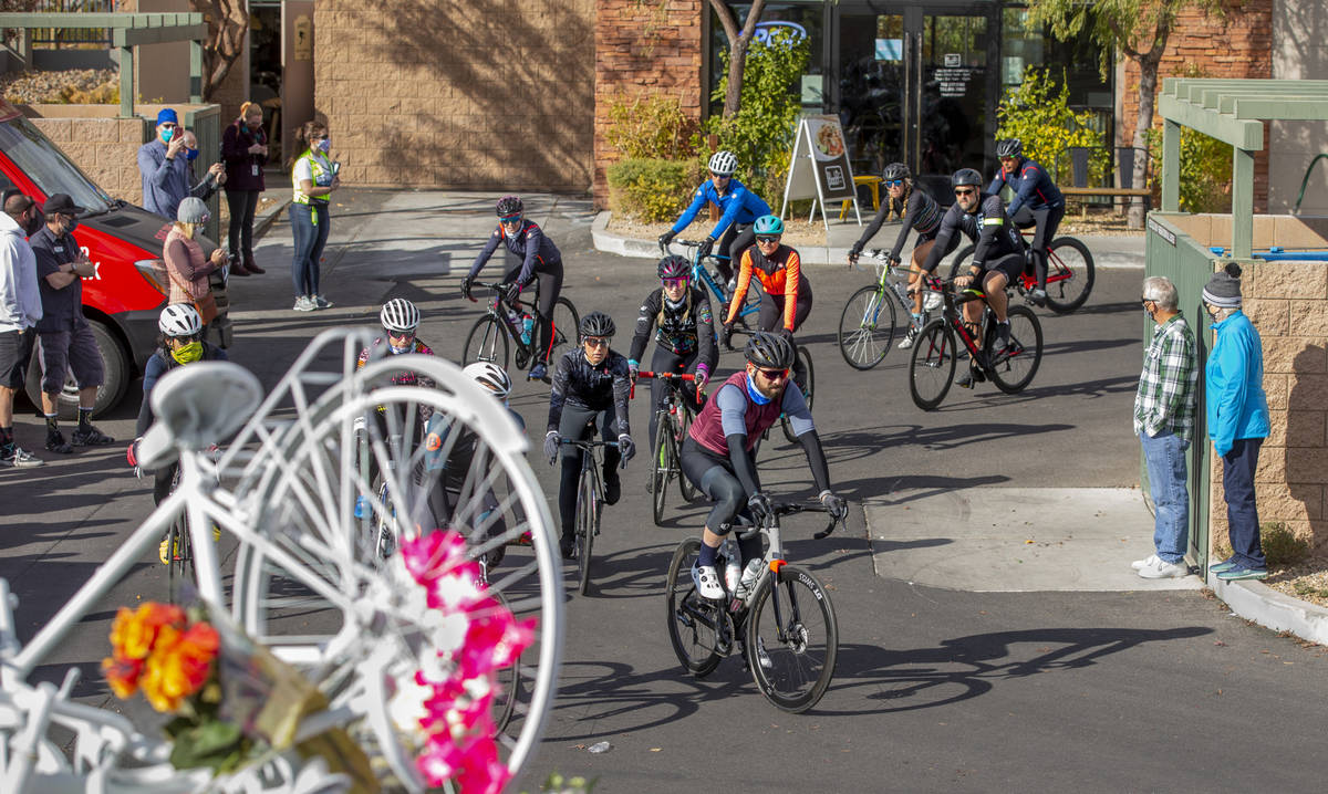 Cyclist do a ride-by tribute during a vigil honoring the lives of five Las Vegas cyclists who l ...