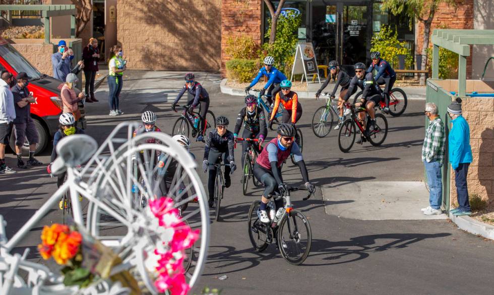 Cyclist do a ride-by tribute during a vigil honoring the lives of five Las Vegas cyclists who l ...