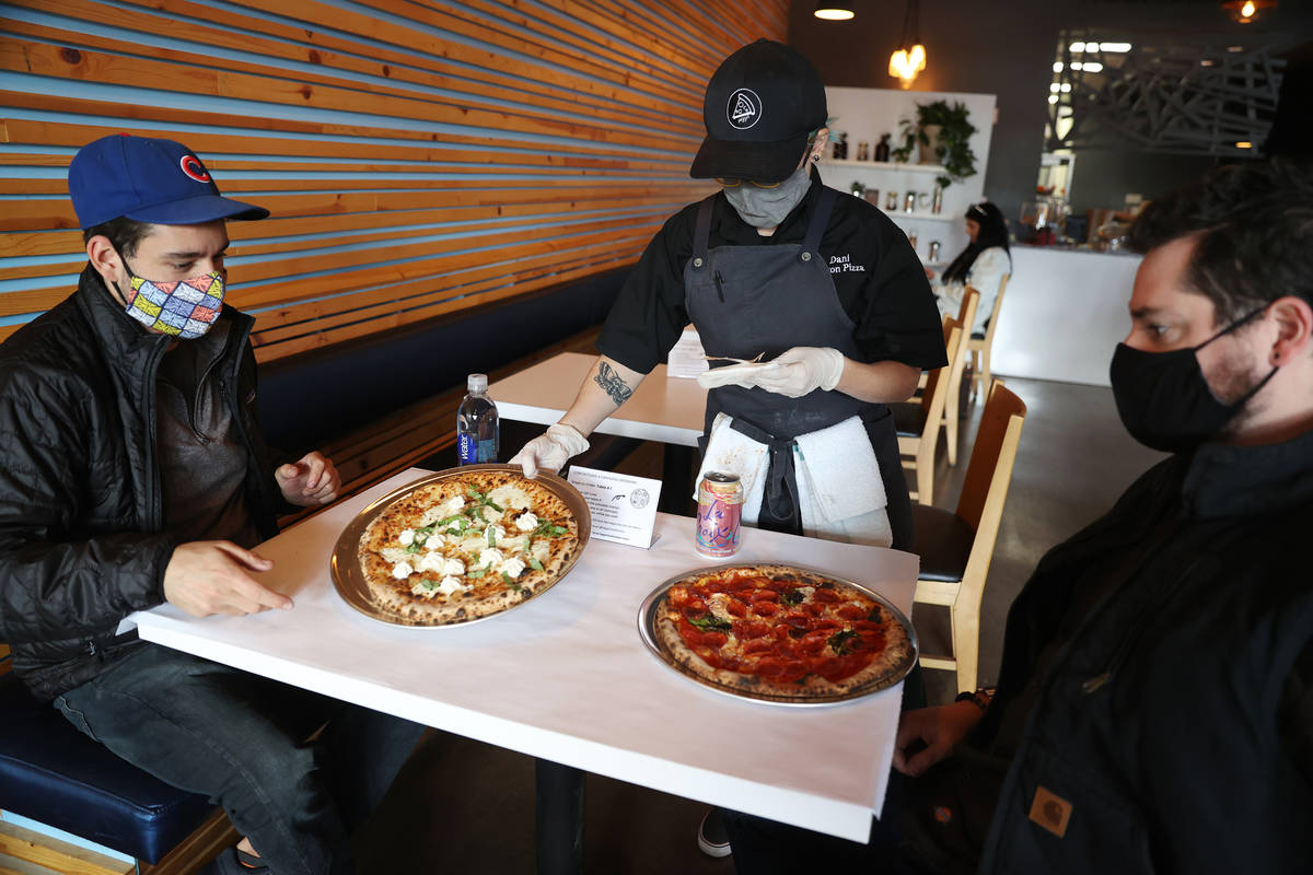 Jason Bielsker, left, and his friend Sam Tepper, receive their food from Dani Garcia-White of Y ...