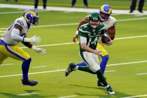 New York Jets quarterback Sam Darnold (14) is chased by Los Angeles Rams' Michael Brockers, lef ...