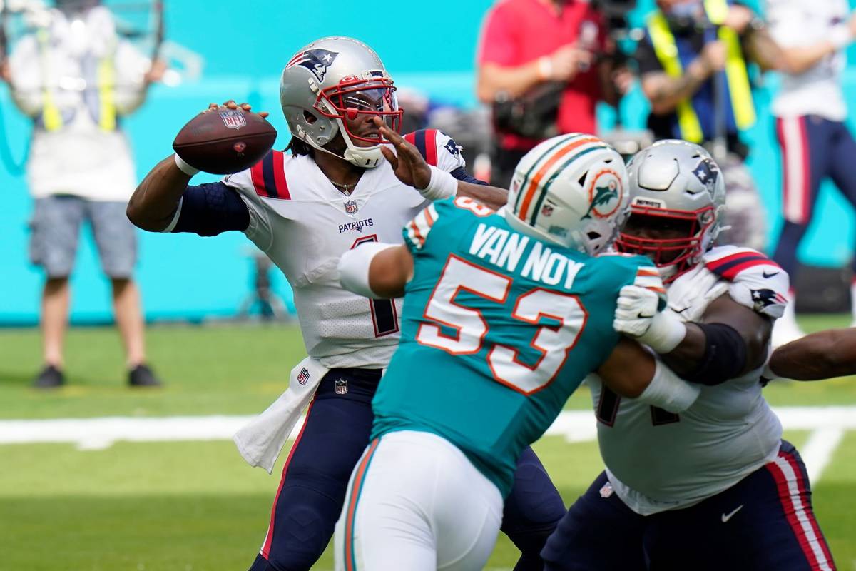 New England Patriots quarterback Cam Newton (1) looks to pass the football during the first hal ...