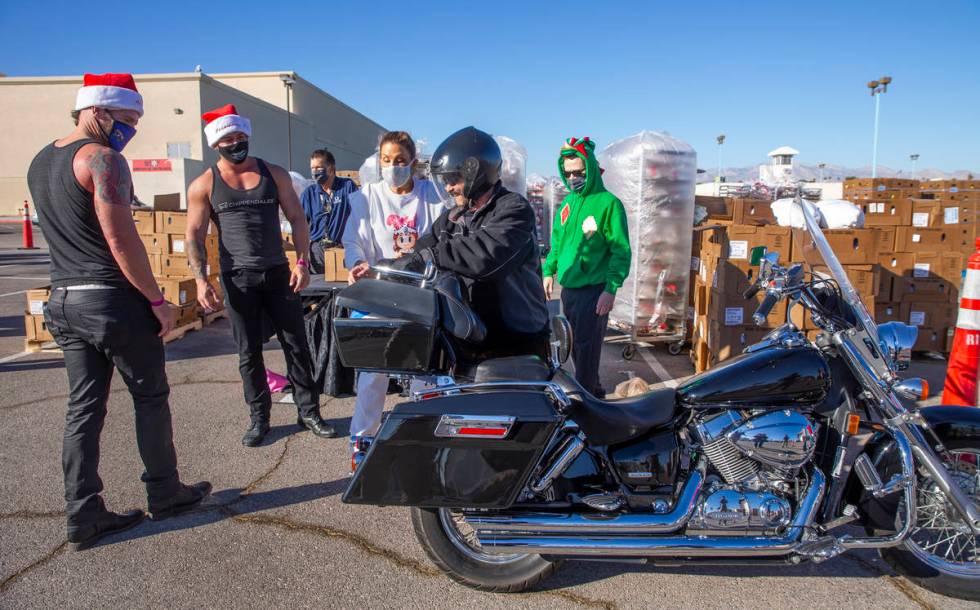 Chippendales' Ryan Kelsey, left, and Ryan Worley, center, with Jade Simone interact with motorc ...