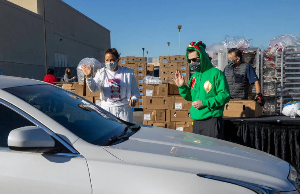 Jade Simone, left, and Piff the Magic Dragon greet another motorist during the re-opening of th ...