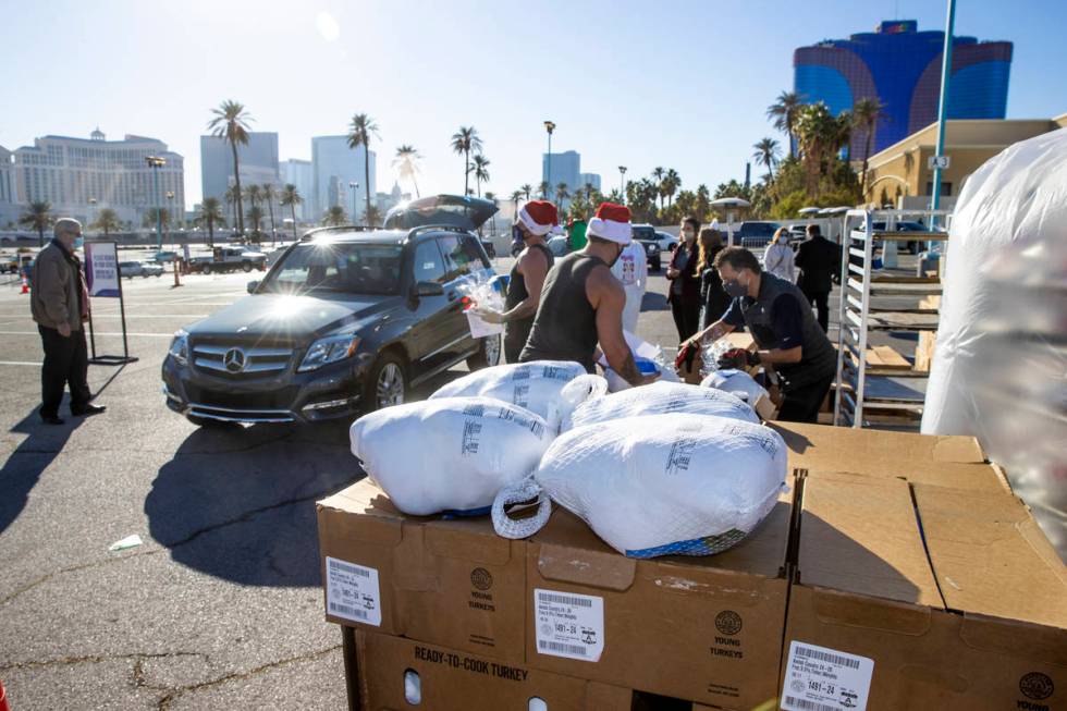 Chippendales members with Jade Simone and Piff the Magic Dragon deliver turkeys and cookies to ...