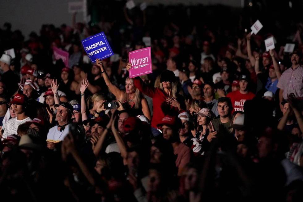 Supporters listen as President Donald Trump speaks at a rally at Minden-Tahoe Airport in Minden ...