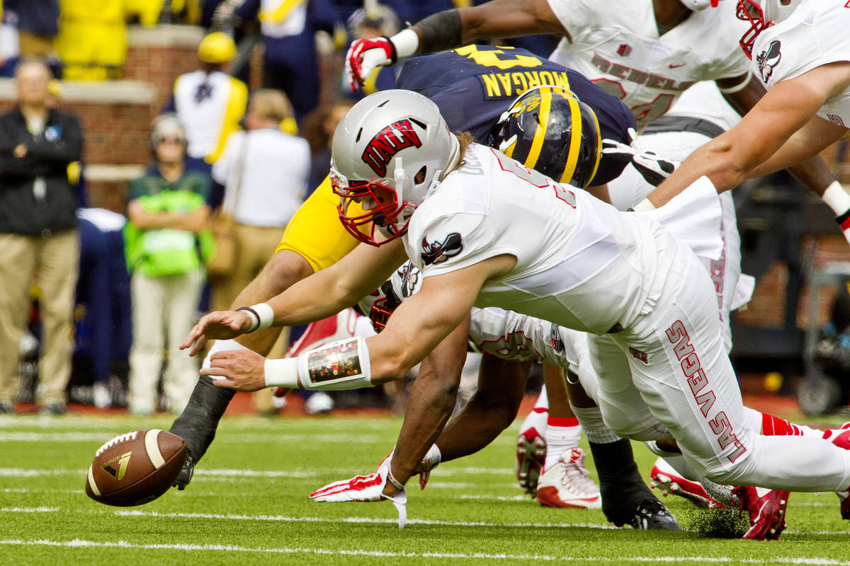 UNLV quarterback Blake Decker (5) recovers his own fumble in the first quarter of an NCAA colle ...
