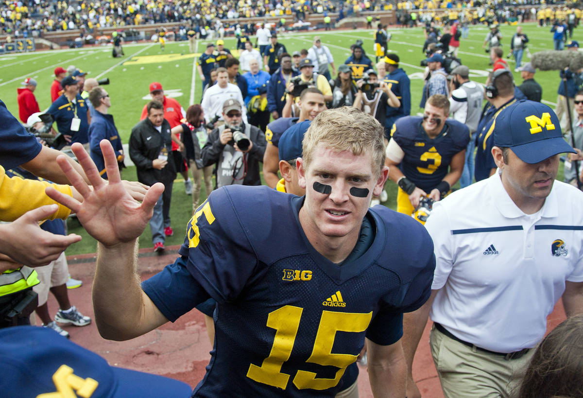 Michigan quarterback Jake Rudock (15) greets fans walking off the field after an NCAA college f ...