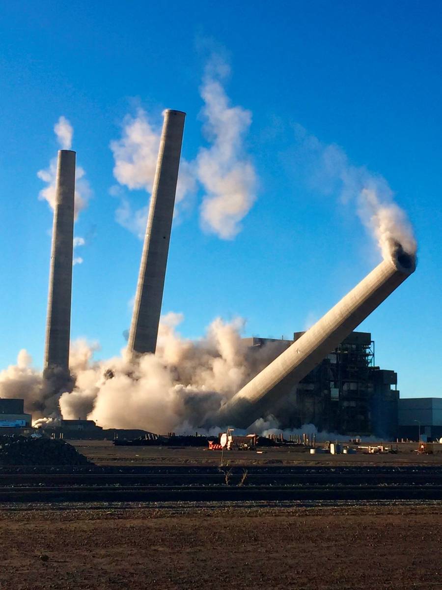 The demolition of a trio of concrete stacks at the Navajo Generating Station is seen near Page, ...