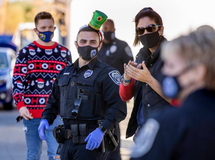 North Las Vegas Police Department P.I.O. Alexander Cuevas, center, joins other volunteers durin ...