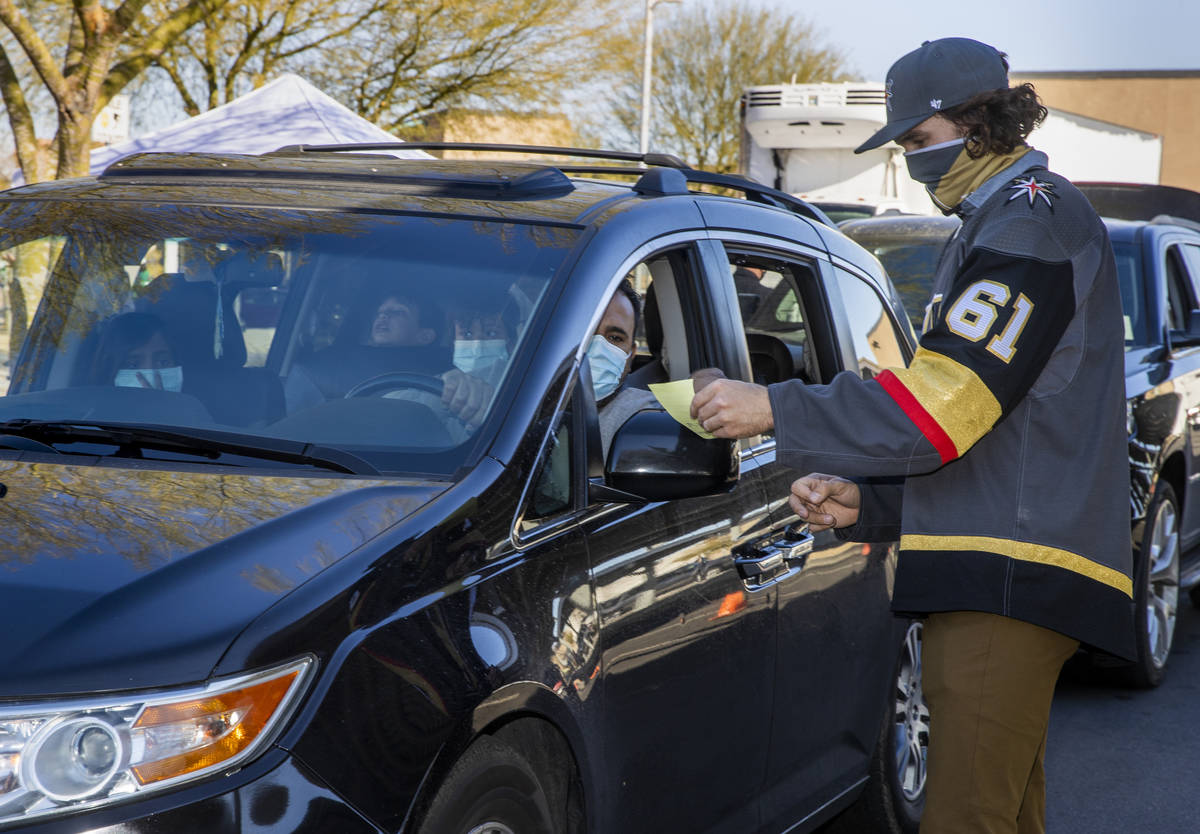 Golden Knights player Mark Stone looks at a gift list for attendees during the first NLVPD Holi ...