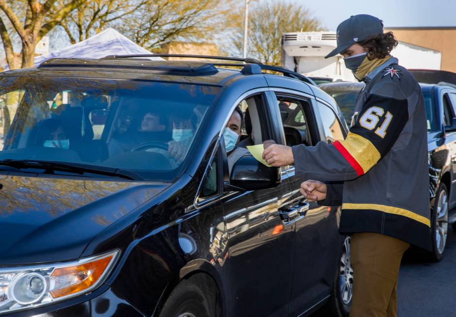 Golden Knights player Mark Stone looks at a gift list for attendees during the first NLVPD Holi ...