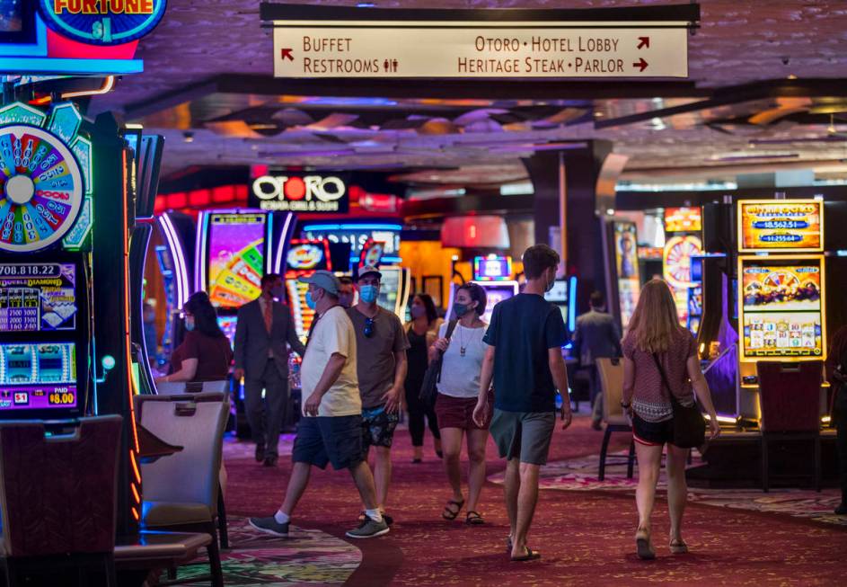 Guests wander about a main walkway in the casino as the Mirage reopens following a COVID-19 shu ...