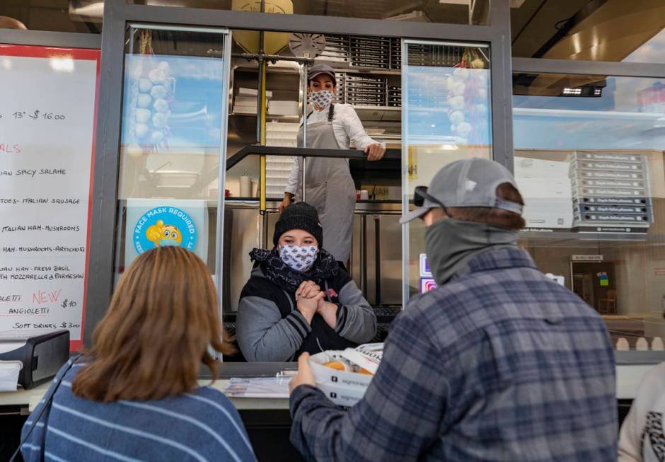 Cashier Demy Somera, center, and chef and owner Floriana Pastore are seen as Las Vegas locals r ...