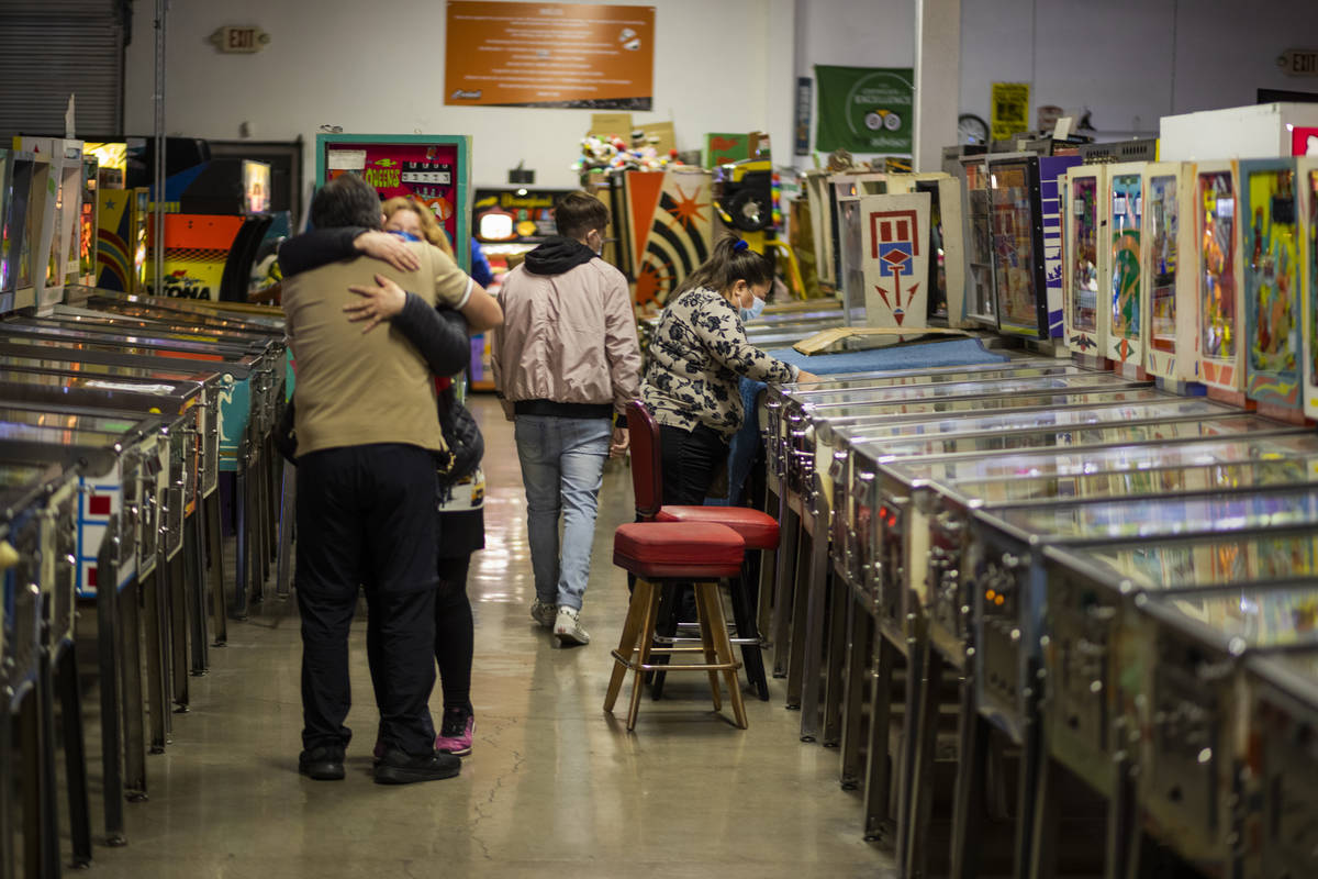 Individuals are seen in the Pinball Hall of Fame during the launch of a weekly food truck gath ...