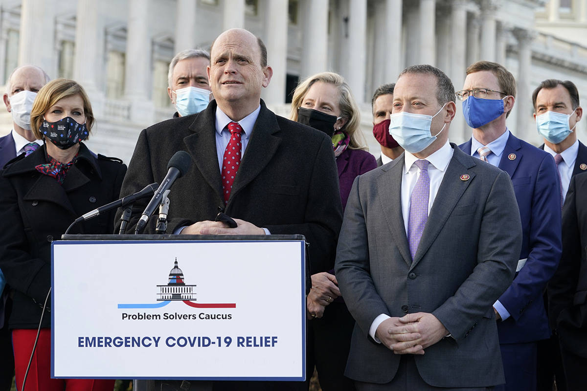 Problem Solvers Caucus co-chairs Rep. Tom Reed, R-N.Y., at podium, and Rep. Josh Gottheimer, D- ...