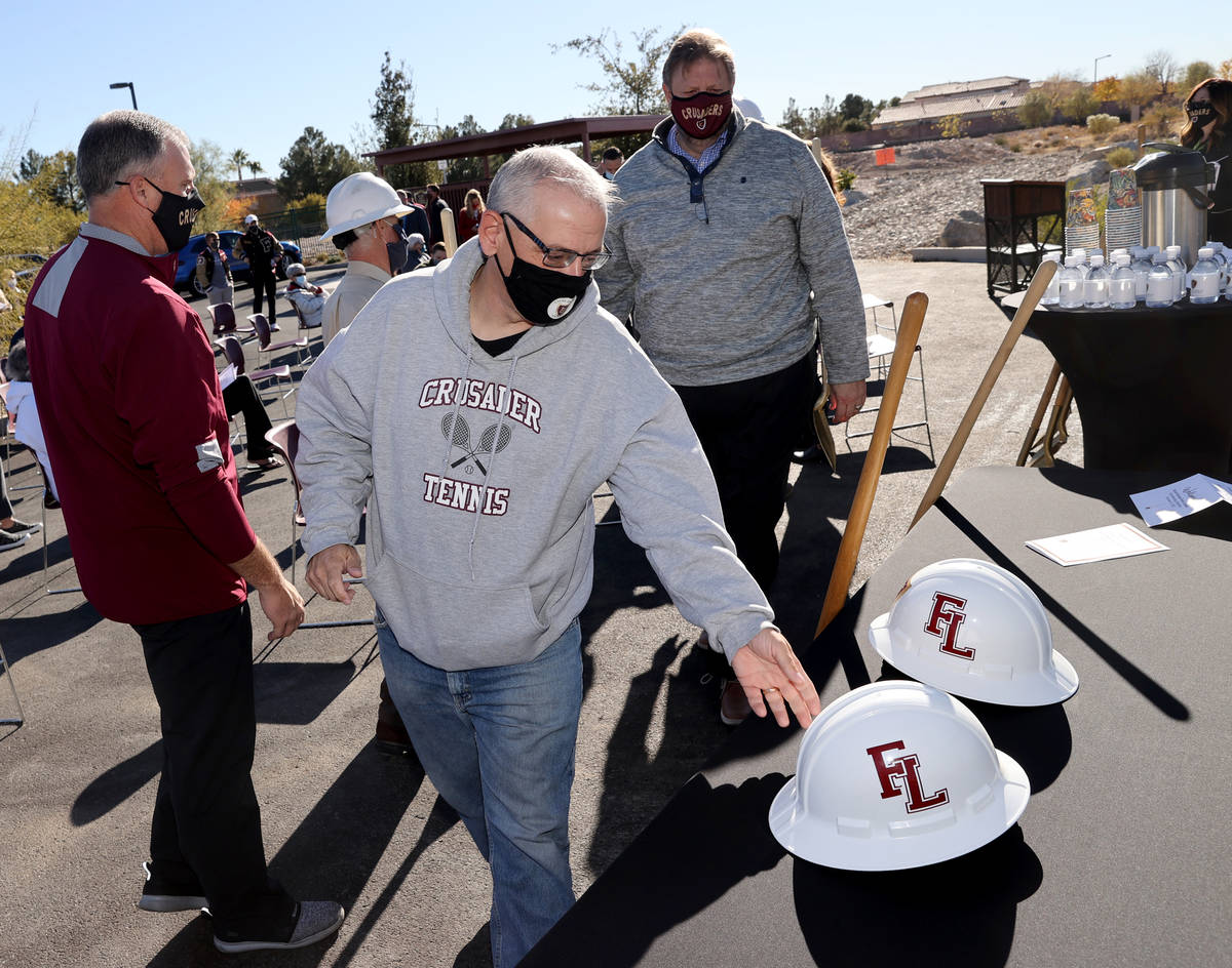 Keith Fridrich, Faith Lutheran Middle School and High School assistant tennis coach, grabs a ha ...