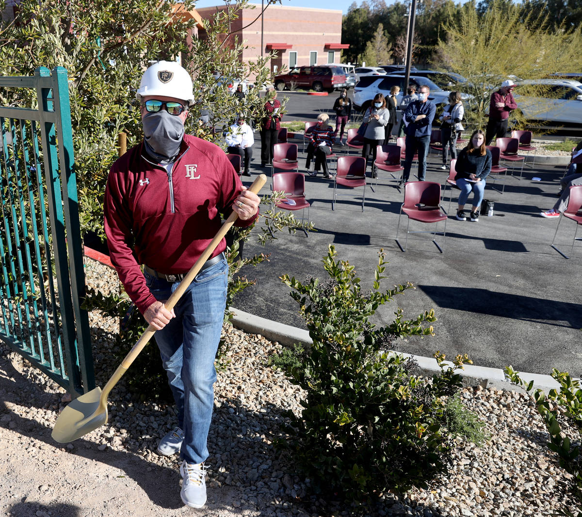 Jeff Foley, Faith Lutheran Middle School and High School tennis coach, grabs a shovel during a ...